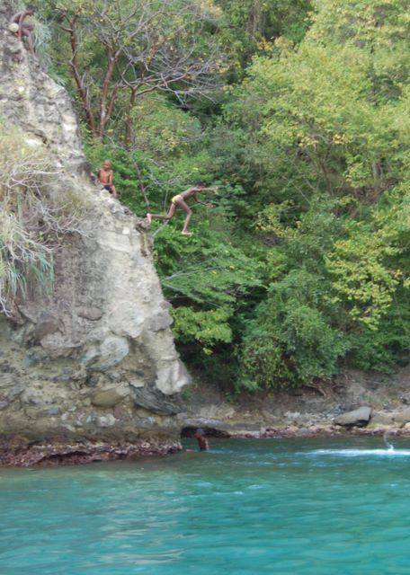 Kids jumping off the rock near the bat cave in Soufriere, St. Lucia