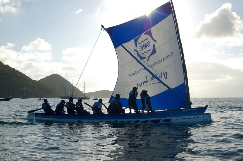 Yole crew in silhouette Rodney Bay, St. Lucia