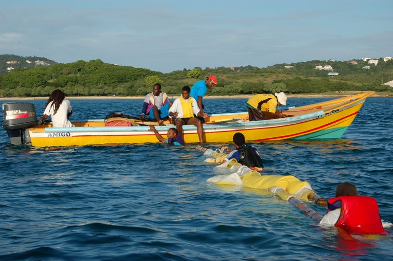 Rescue boat and capsized Yole in Rodney Bay, St. Lucia