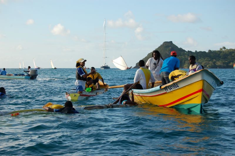 Capsized Yole and rescue boat in front of Pigeon Island
