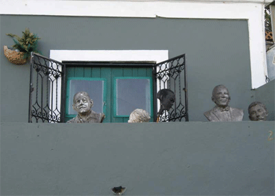 Sculptures of heads on a balcony in San Juan